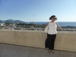 Miaomiao at the southwest side of the square around the Notre-Dame de la Garde basilica, with a view on the Massif des Calanques mountain range and the south side of the city