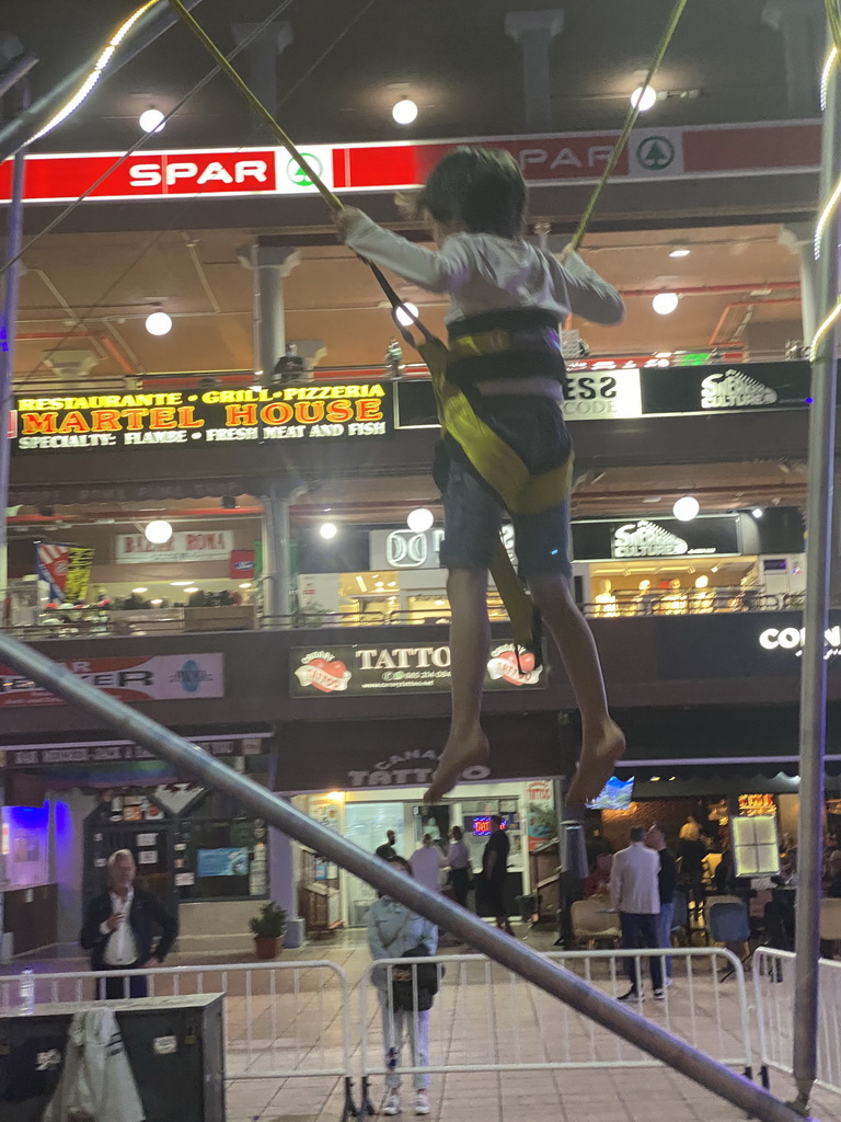 Max jumping at the bungee trampoline at the Yumbo Centrum shopping mall, by night