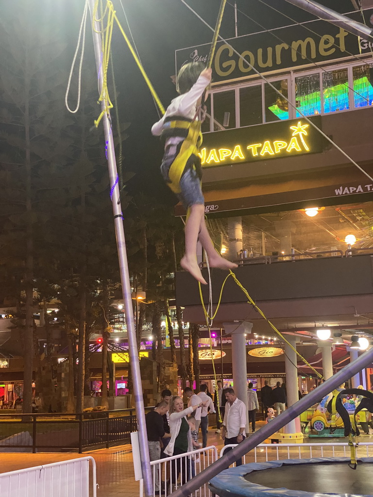 Max jumping at the bungee trampoline at the Yumbo Centrum shopping mall, by night