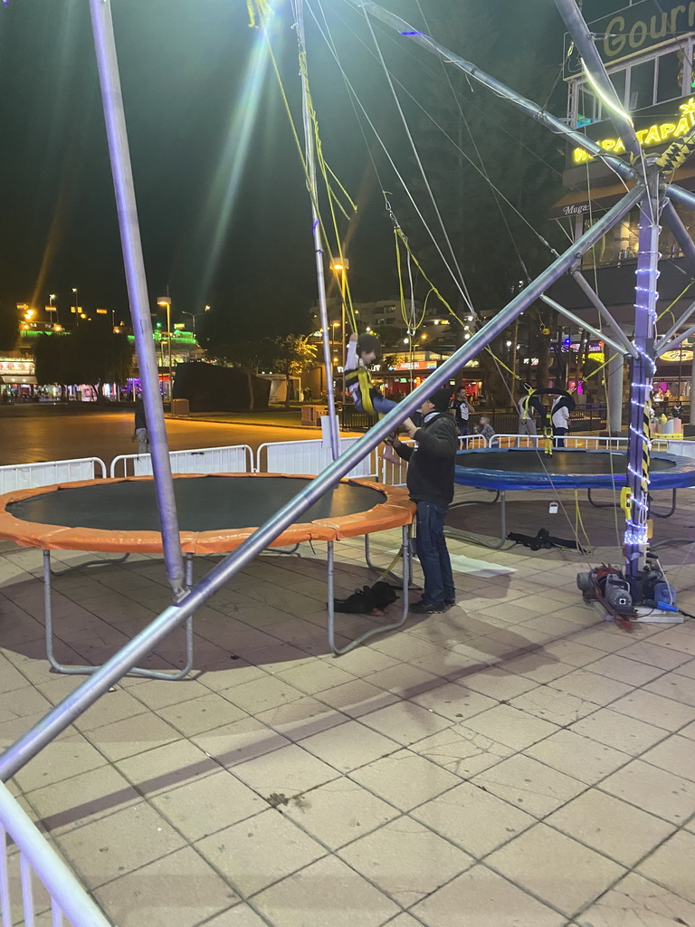 Max being helped at the bungee trampoline at the Yumbo Centrum shopping mall, by night