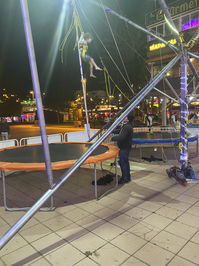 Max jumping at the bungee trampoline at the Yumbo Centrum shopping mall, by night