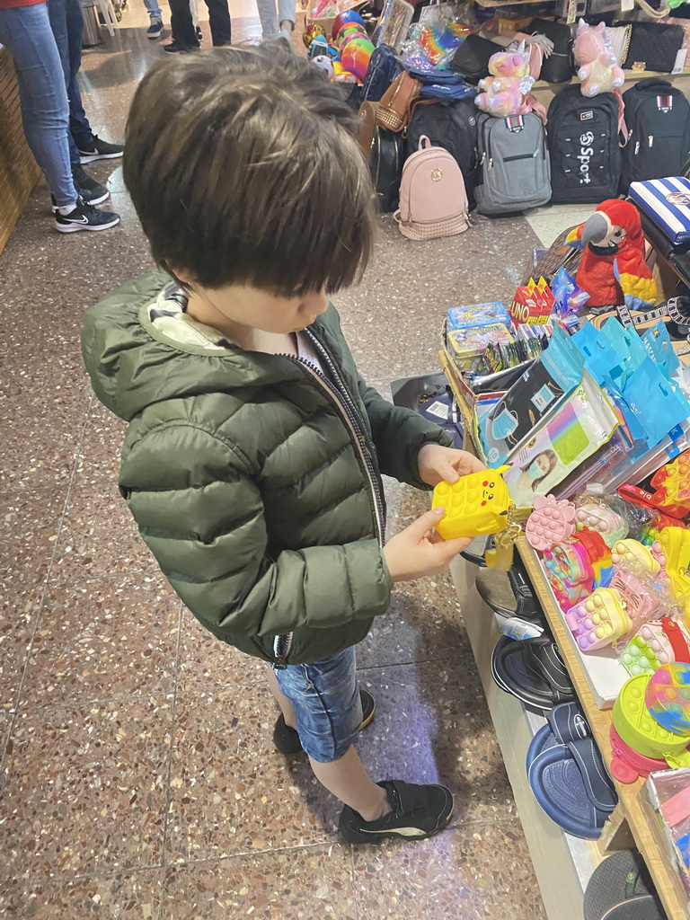 Max with toys at a shop at the Yumbo Centrum shopping mall, by night