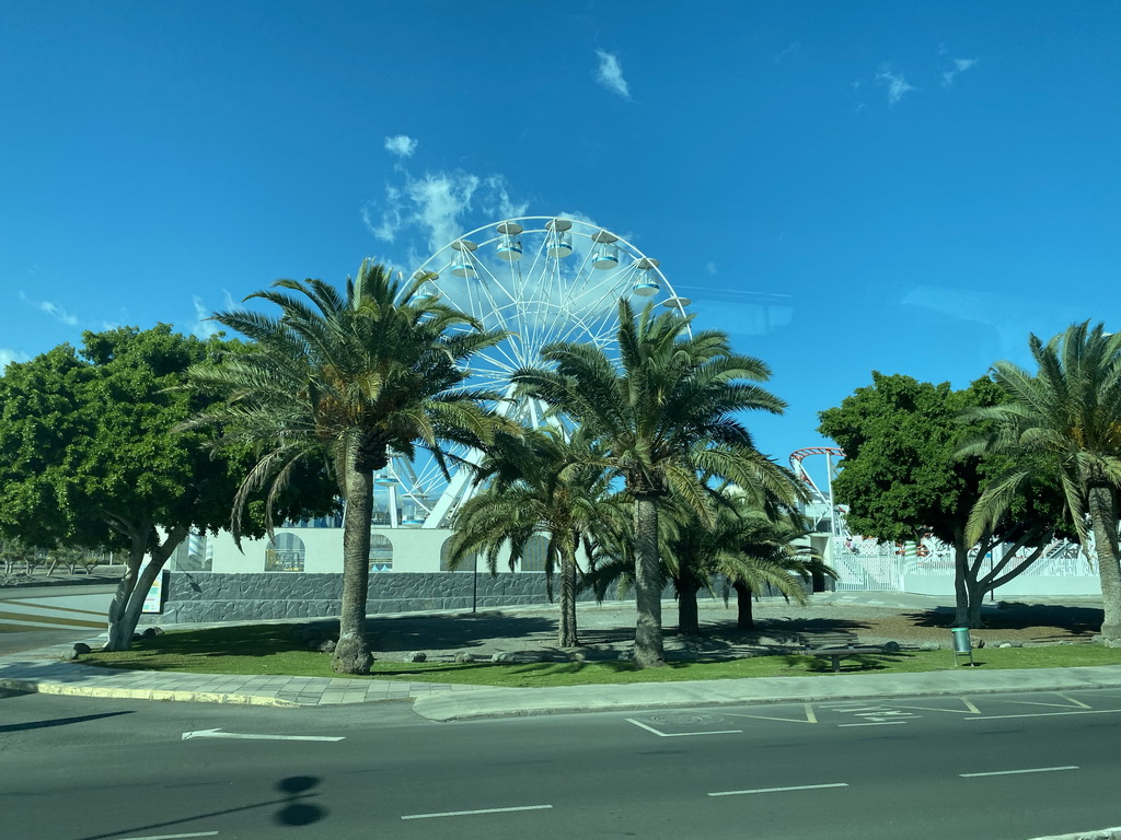 Ferris wheel at the Holiday World Maspalomas Center theme park at the Avenida Touroperador Tui street, viewed from the bus from the Palmitos Park