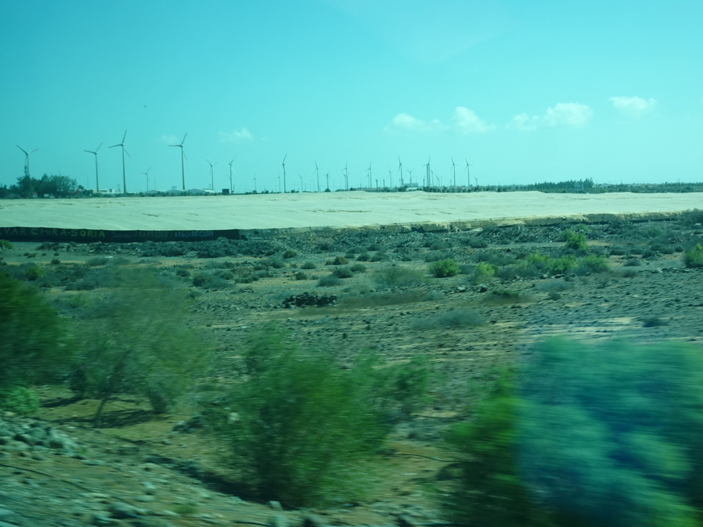 Greenhouses and windmills near the Cañada de la Cebolleta ravine, viewed from the bus to Las Palmas at the GC-1 road