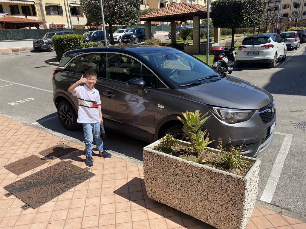 Max with our rental car in front of the House of Mola apartment at the Via della Stadera street