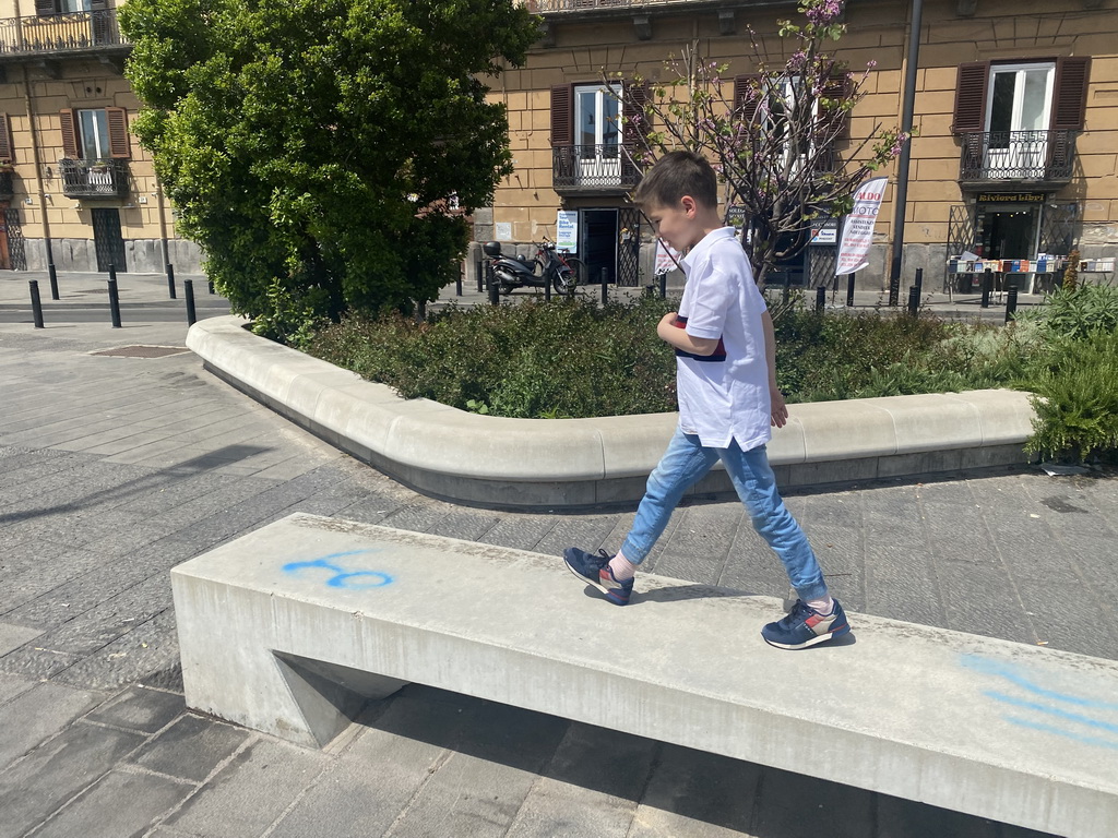 Max walking on a bench at the Riviera di Chiaia street