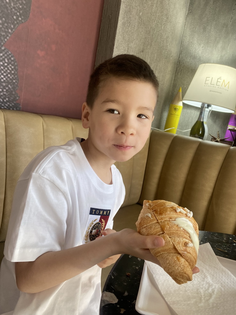 Max eating a croissant at the Zenit Café