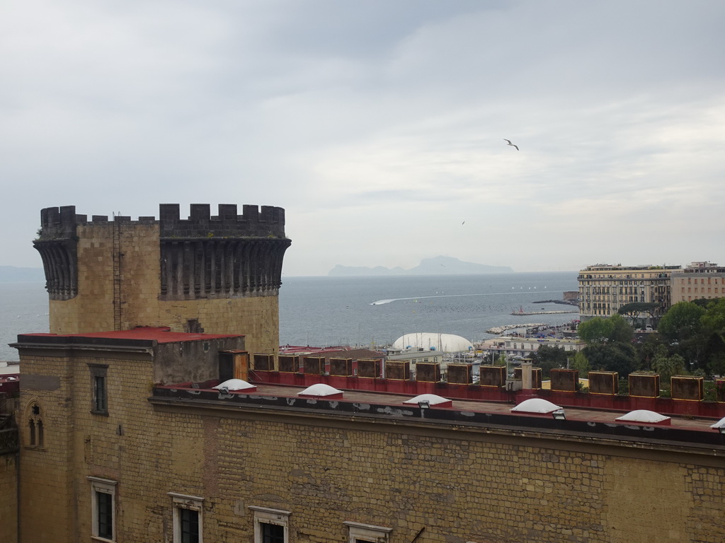 Southeast side of the Castel Nuovo castle with the Gold Tower, the Porticciolo di Santa Lucia marina, the Gulf of Naples and the island of Capri, viewed from the northwest side of the roof