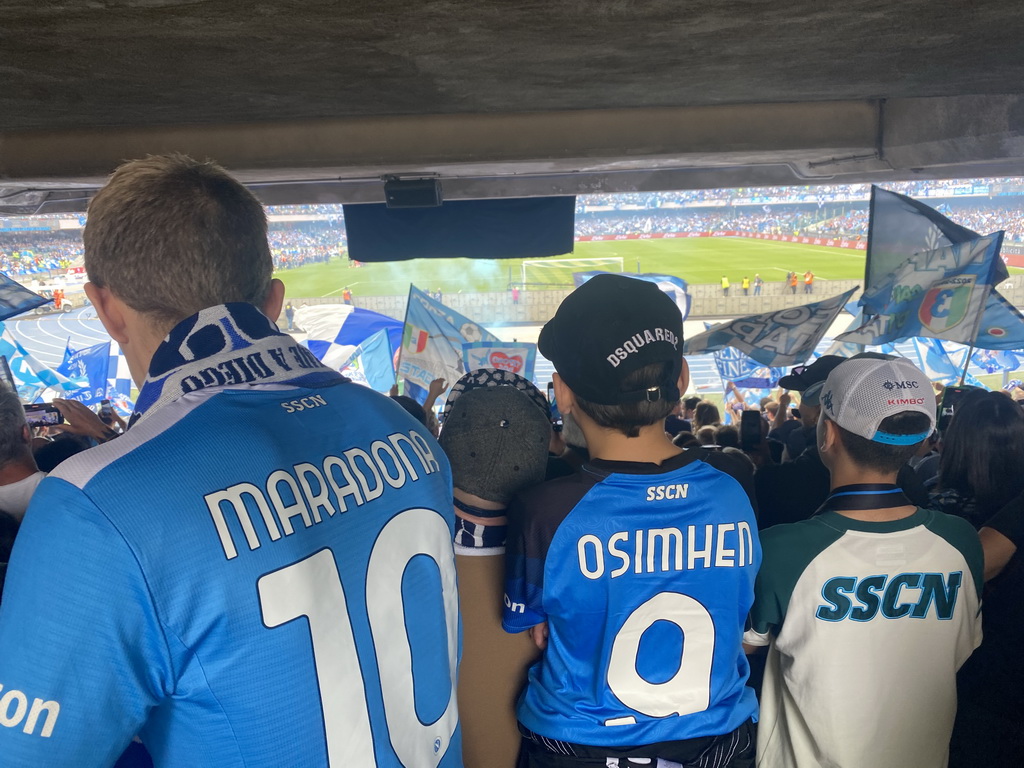 Football fans at the Curva A Inferiore grandstand and players entering the pitch at the Stadio Diego Armando Maradona stadium, just before the football match SSC Napoli - Salernitana