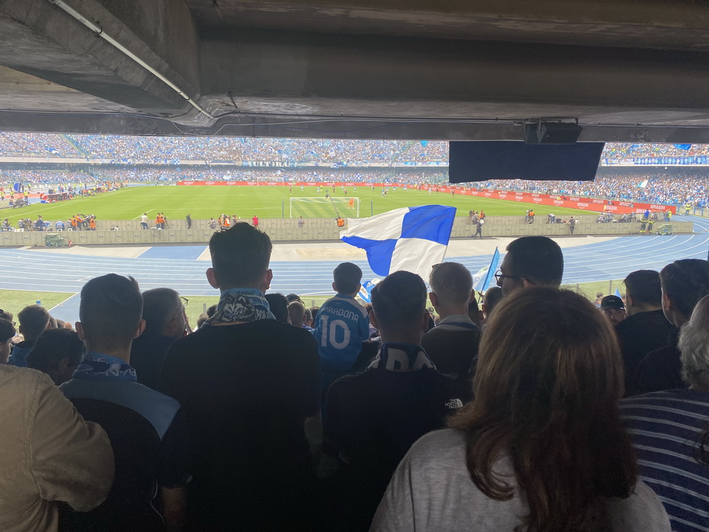 Football fans at the Curva A Inferiore grandstand and players on the pitch at the Stadio Diego Armando Maradona stadium, during the football match SSC Napoli - Salernitana