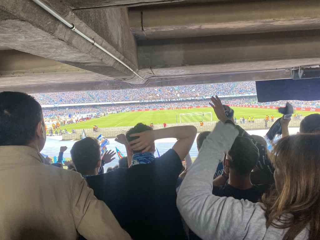 Players on the pitch and football fans at the Curva B grandstand celebrating a SSC Napoli goal at the Stadio Diego Armando Maradona stadium, during the football match SSC Napoli - Salernitana