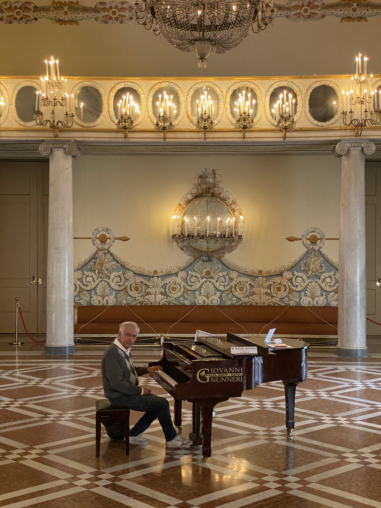 Piano player and audience at the Salone delle Feste room at the First Floor of the Museo di Capodimonte museum