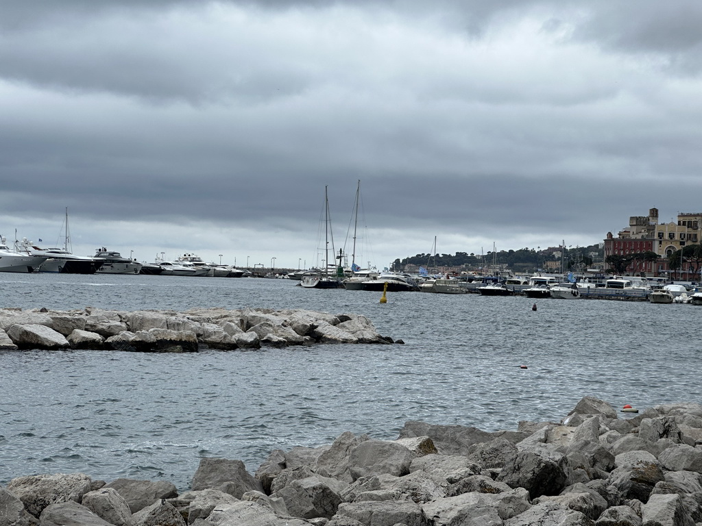 The beach at the Via Caracciolo Francesco street and boats at the Sannazaro Port