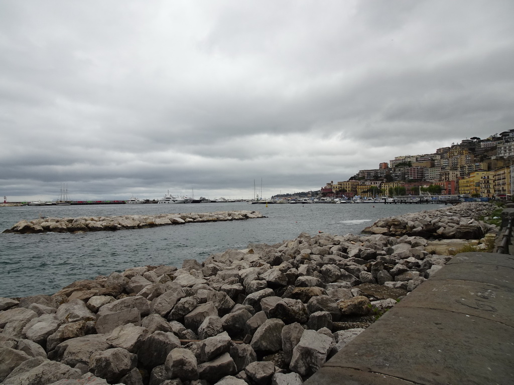 The beach at the Via Caracciolo Francesco street and boats at the Sannazaro Port