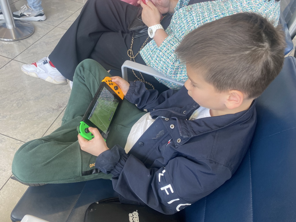 Max playing FIFA 23 on the Nintendo Switch at the Departures Hall of Naples International Airport