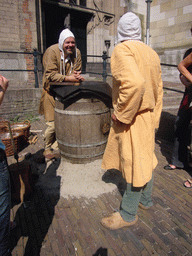 People in medieval clothes in front of the Sint Stevenskerk church at the Sint Stevenskerkhof square, during the Gebroeders van Limburg Festival