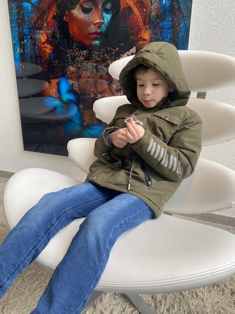 Max eating a chocolate easter egg at the lobby at the Ground Floor of the Sanadome Hotel & Spa