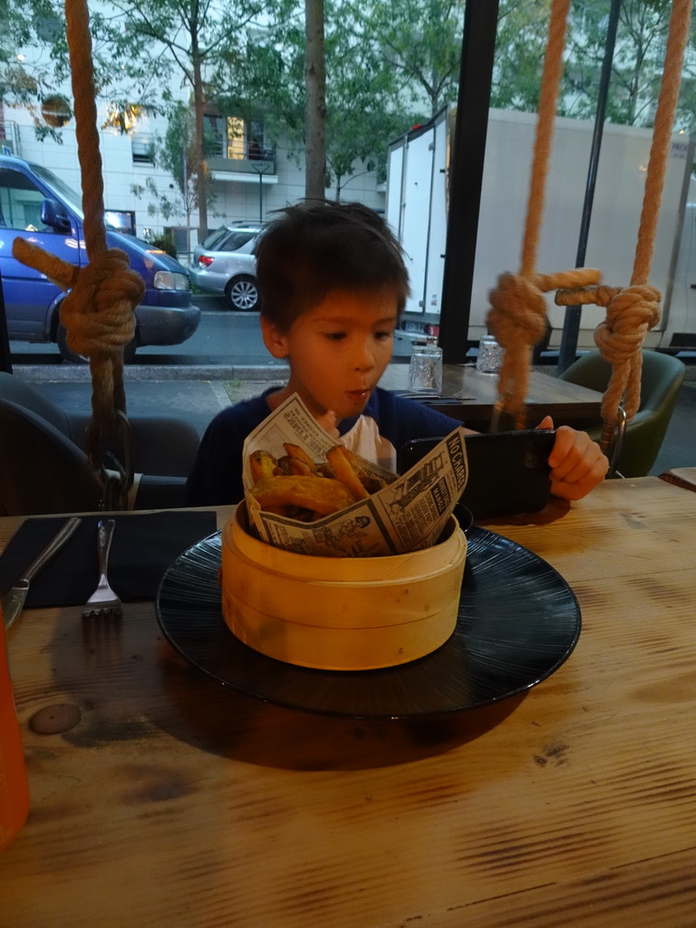 Max on a swing having dinner at the Le Baoma restaurant