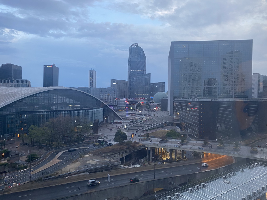 The Parvis de la Défense square with the Tour Sequoia tower, the CNIT shopping mall, the Le Pouce statue, the Westfield Les 4 Temps shopping mall, the Tour Hekla tower and the Grande Arche de la Défense building, viewed from the window of our room at the Pullman Paris La Défense hotel, at sunset