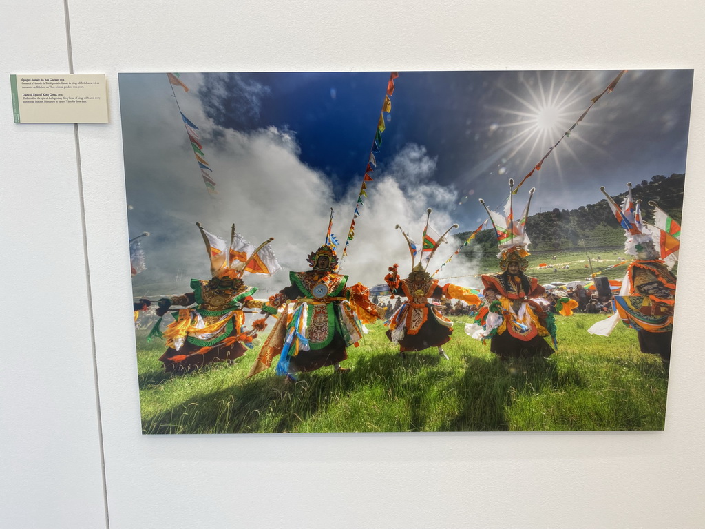 Photograph of the Danced Epic of King Gesar at the exhibition `Hymne à la Beauté` at the top floor of the Grande Arche de la Défense building, with explanation