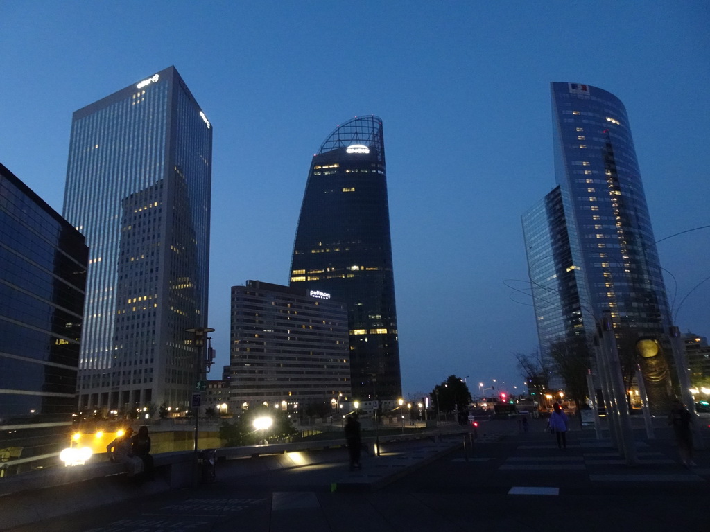 Front of the Pullman Paris La Défense hotel and skyscrapers at the Avenue de l`Arche, viewed from the Parvis de la Défense square, by night