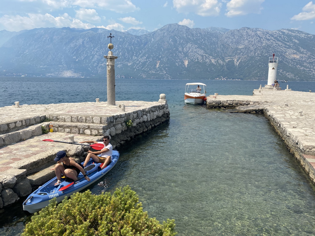 Pillar, boats and naval beacon at the northwest side of the Our Lady of the Rocks Island