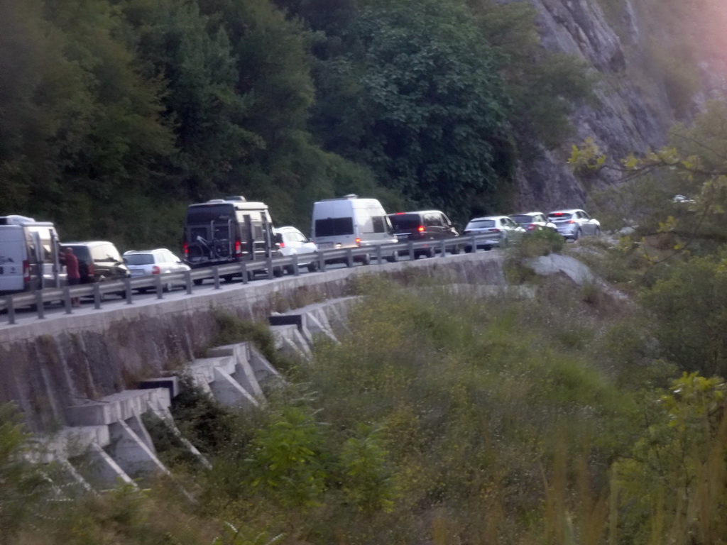 Cars waiting in line for the Montenegro-Croatia border crossing near the town of Sutorina, viewed from the tour bus on the E65 road