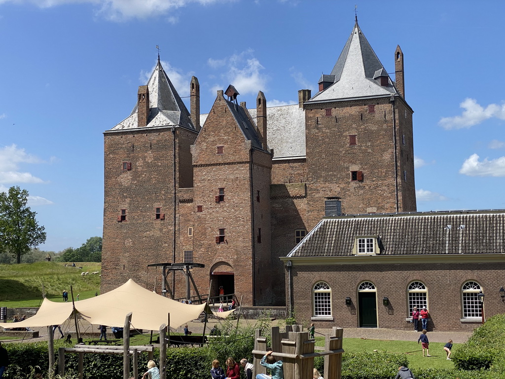 Main square with playground in front of the southeast side of Loevestein Castle