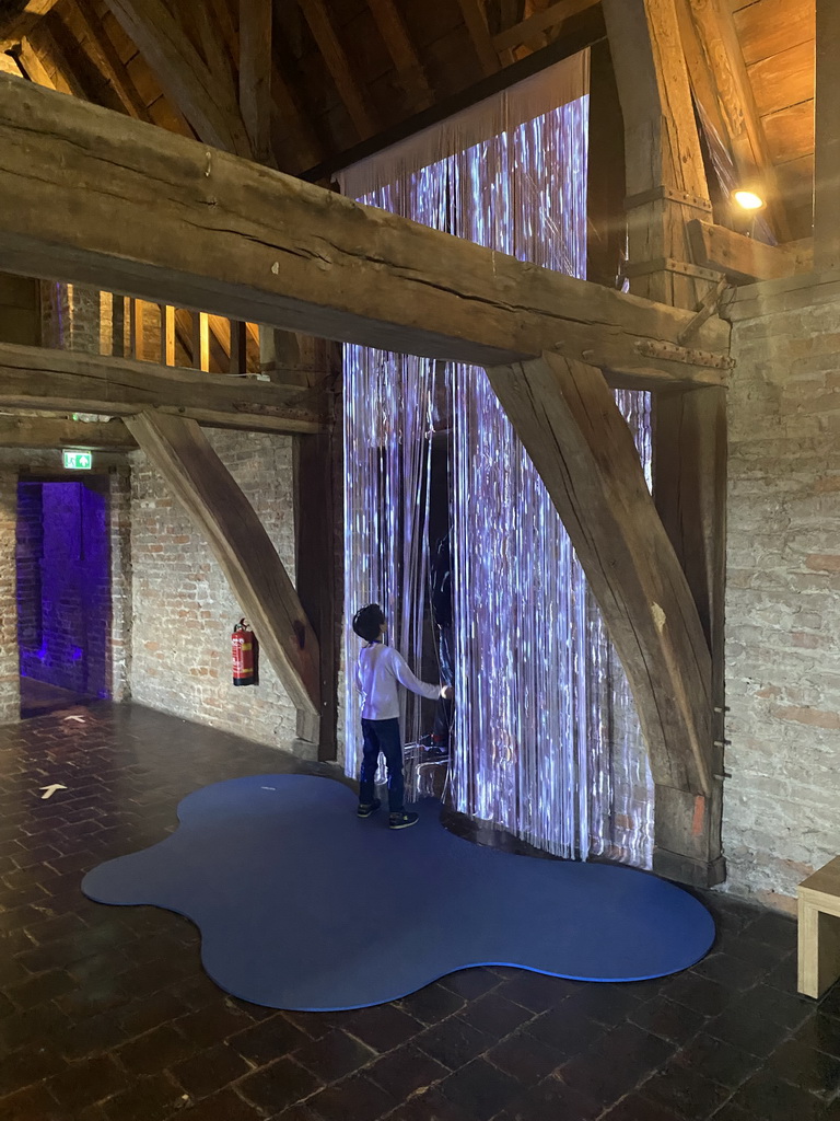 Max with a fake waterfall at the `Denkend aan Water` exhibition at the Top Floor of Loevestein Castle