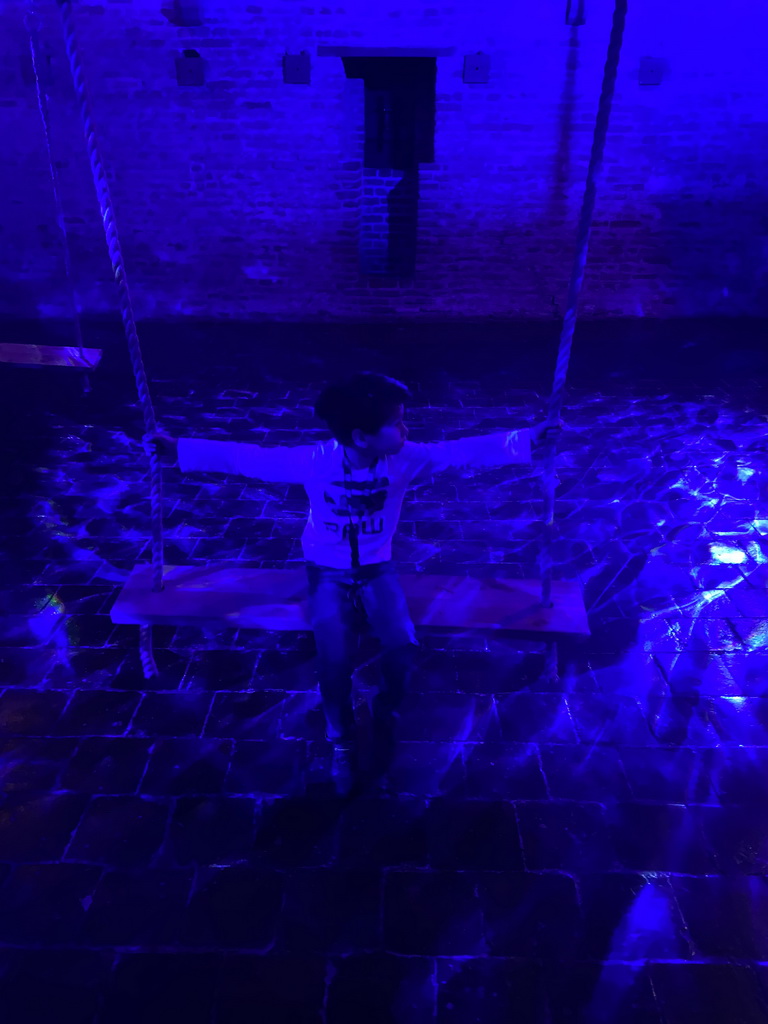 Max on a swing at the `Denkend aan Water` exhibition at the Top Floor of Loevestein Castle