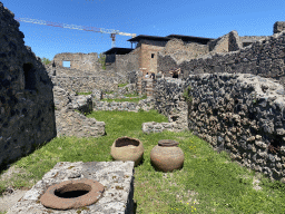 Walls and pottery at the House of Romulus and Remus at the Pompeii Archeological Site, viewed from the Via Marina street