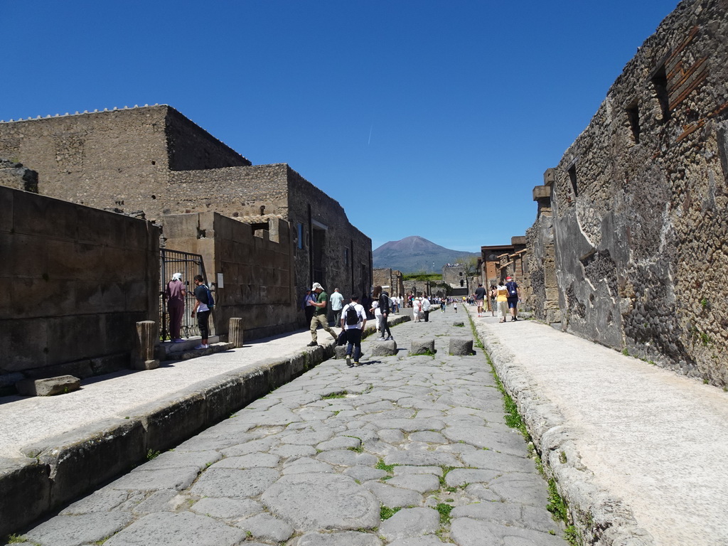 The Via di Mercurio street and the Torre XI tower at the Pompeii Archeological Site, with a view on Mount Vesuvius