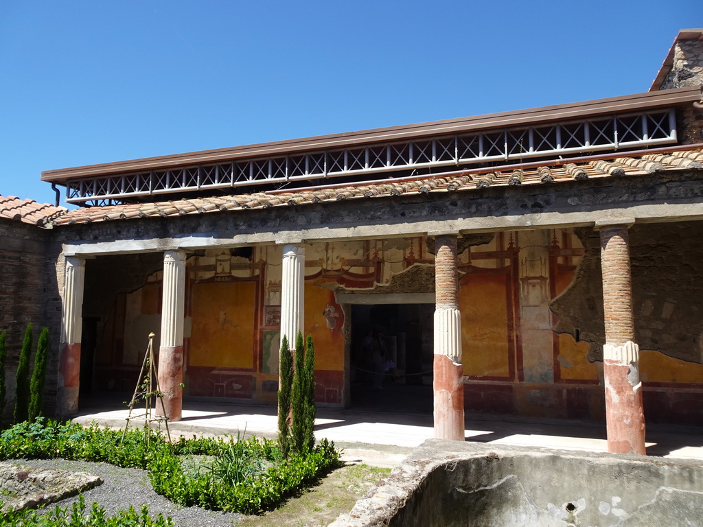 Columns and walls with frescoes at the Main Atrium of the House of the Dioscuri at the Pompeii Archeological Site