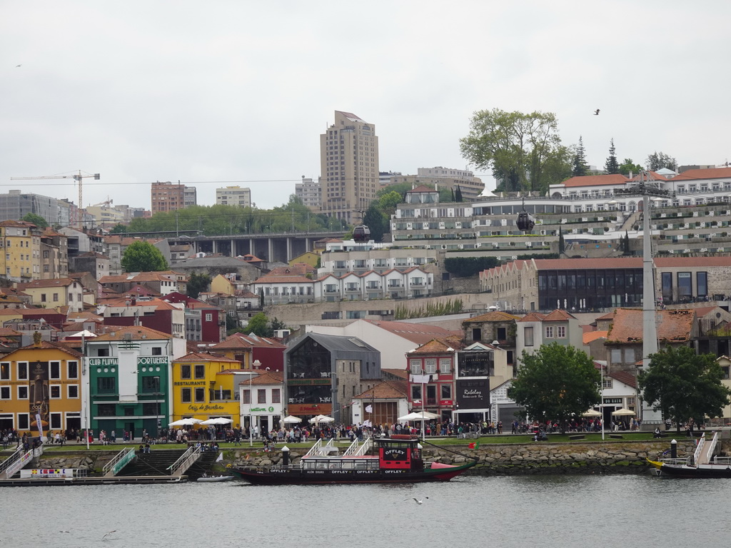 Boats on the Douro river and Vila Nova de Gaia with the Gaia Cable Car, viewed from the Cais da Estiva street