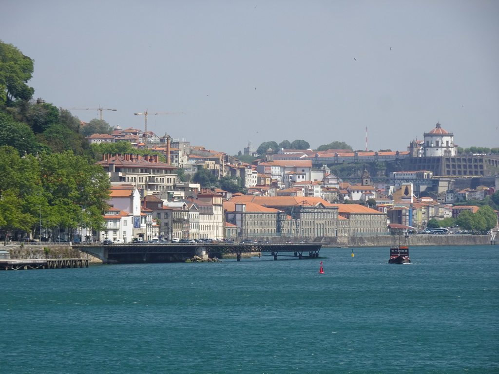 The Alfândega do Porto building, boat on the Douro river and Vila Nova de Gaia with the Mosteiro da Serra do Pilar monastery, viewed from the sightseeing bus