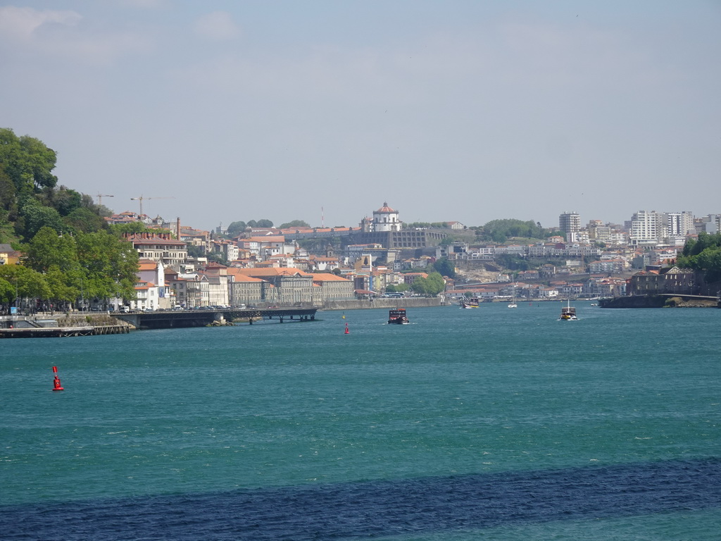 The Alfândega do Porto building, boats on the Douro river and Vila Nova de Gaia with the Mosteiro da Serra do Pilar monastery, viewed from the sightseeing bus