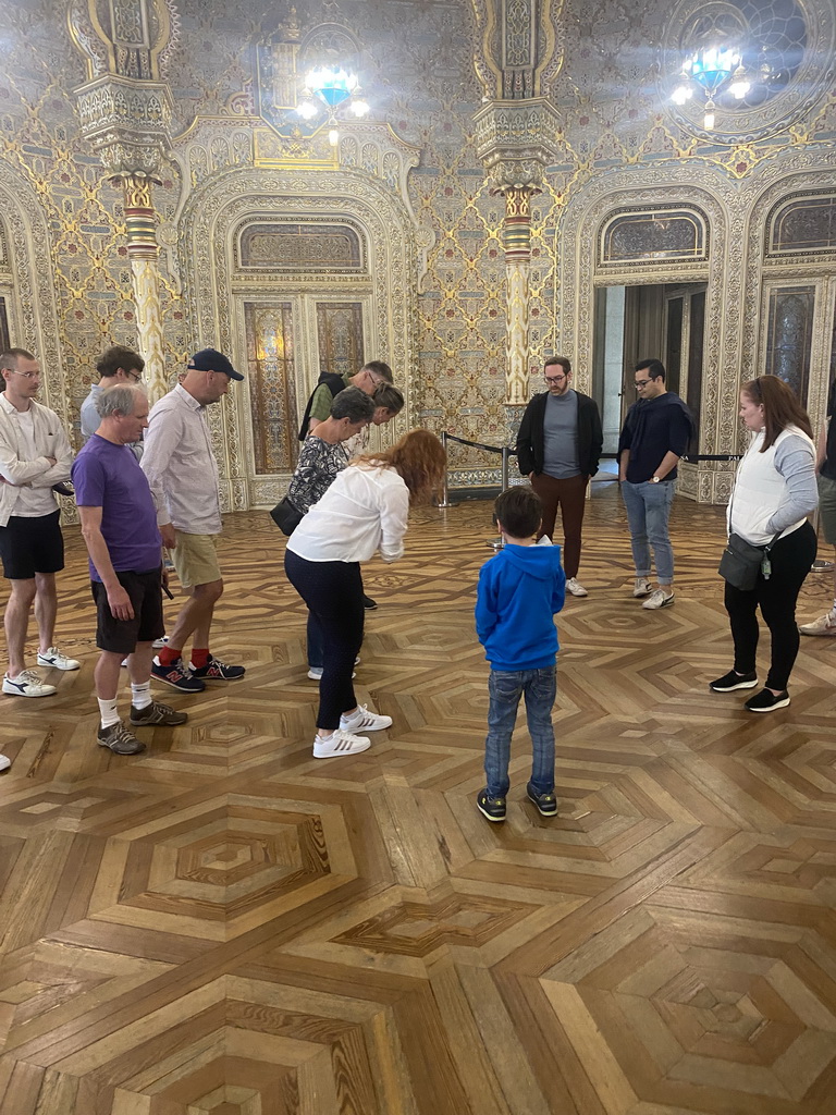 Max helping our tour guide at the east side of the Arab Room at the northwest side of the upper floor of the Palácio da Bolsa palace