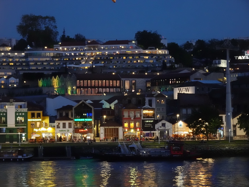 Boats on the Douro river and Vila Nova de Gaia with the Avenida de Diogo Leite street, viewed from the Muro do Bacalhau restaurant, at sunset