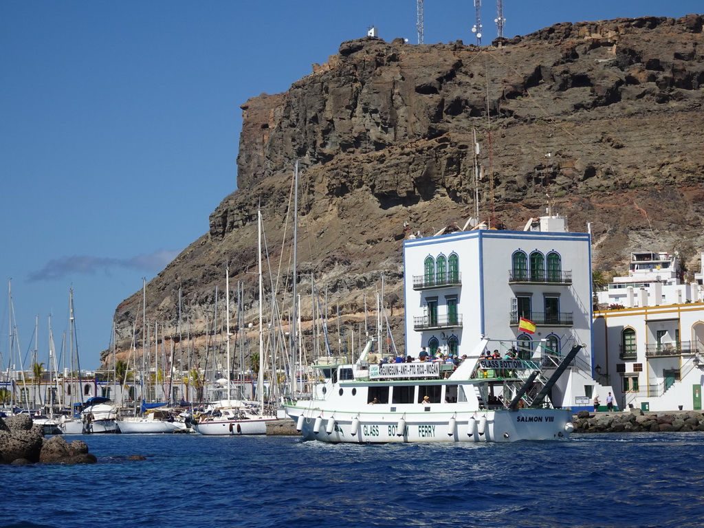 Boat in front of the harbour and the Hotel THe Puerto de Mogán, viewed from the Sagitarius Cat boat