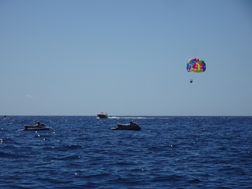 Parasail and jet skis, viewed from the Sagitarius Cat boat