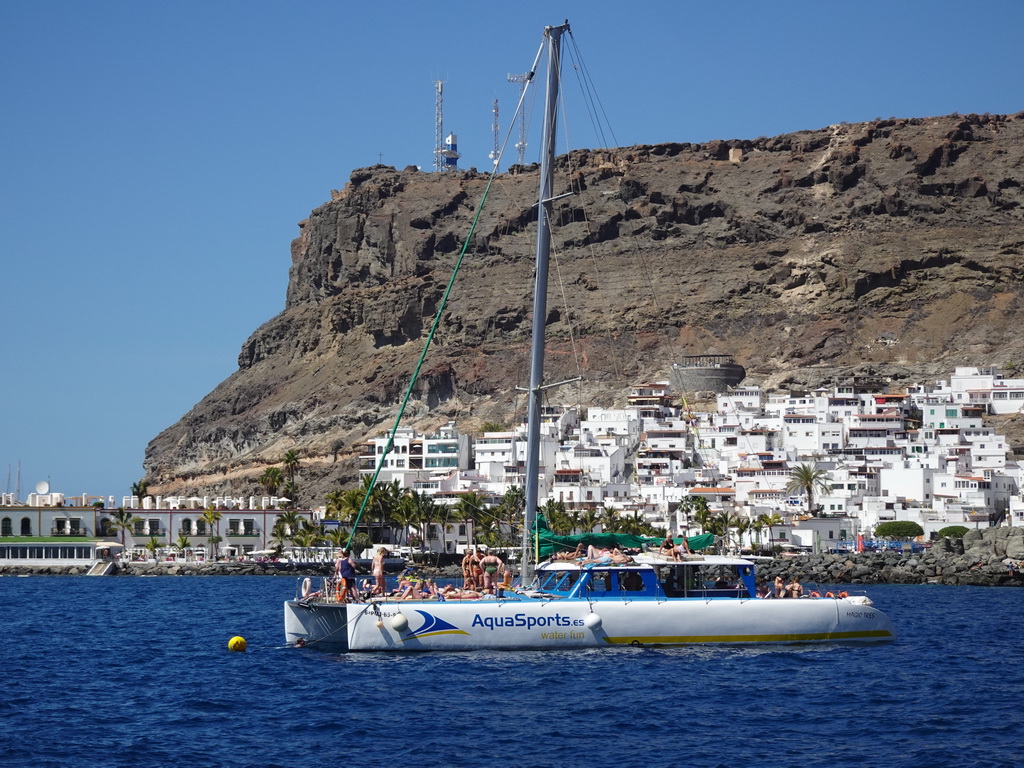 Boat in front of the town center with the Hotel THe Puerto de Mogán, viewed from the Sagitarius Cat boat