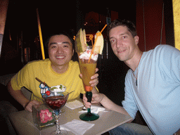 Tim and Miaomiao`s friend having a cocktail in a cocktail bar in the city center