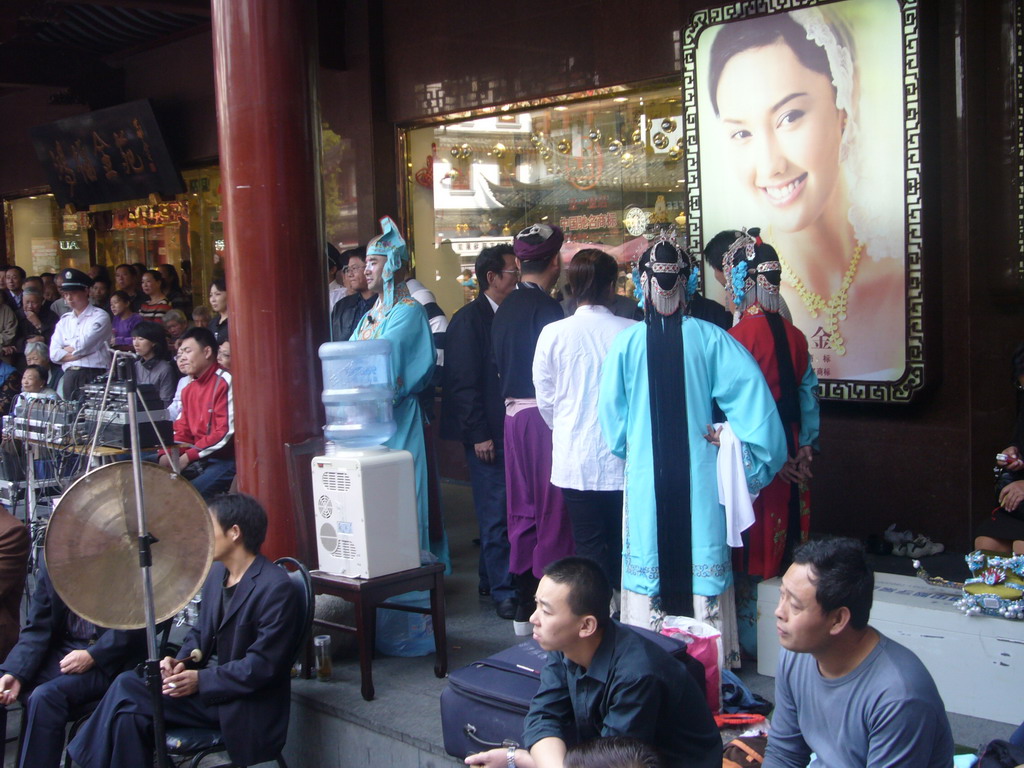 People performing a Chinese Opera at the shopping area just outside of the Temple of the Town Gods