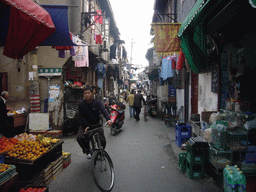 Lilong with a food shop and laundry hanging outside