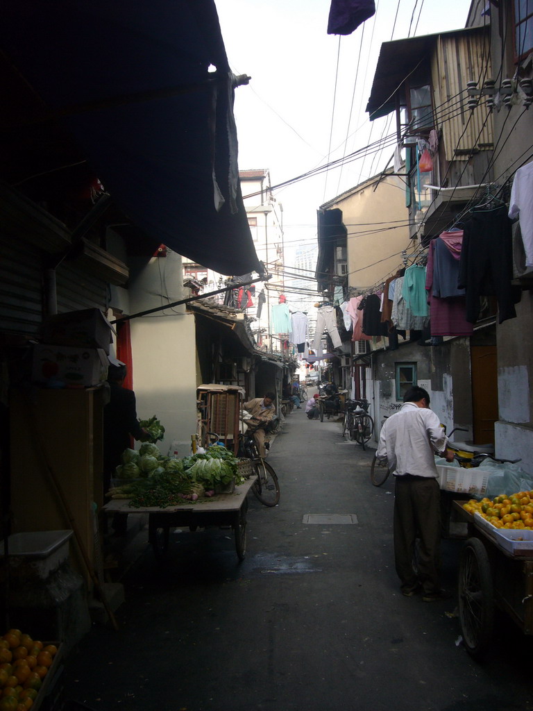 Lilong with a food shop and laundry hanging outside