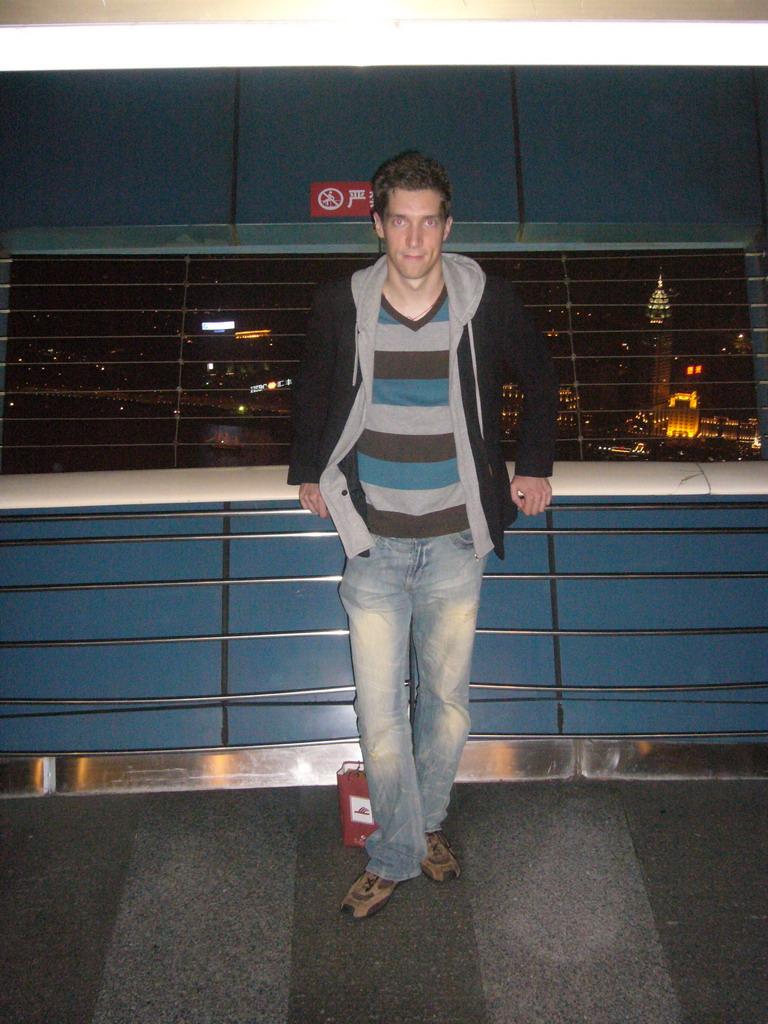 Tim at the top of the Oriental Pearl Tower, with a view on the Puxi skyline with the Guang Ming Building, by night