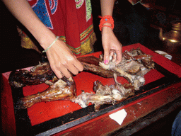 Yak meat being prepared on our table in the Tibetan dinner house
