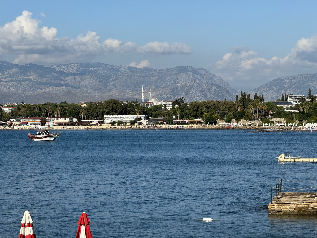 Boats in the Gulf of Antalya and beaches, hotels and a mosque at the northwest side of town, viewed from the seaside path near the Turgut Reis Caddesi street