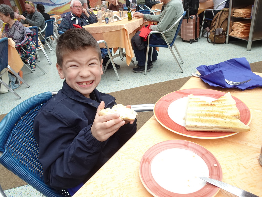 Max eating bread at the terrace of the Fauno Bar at the Piazza Torquato Tasso square