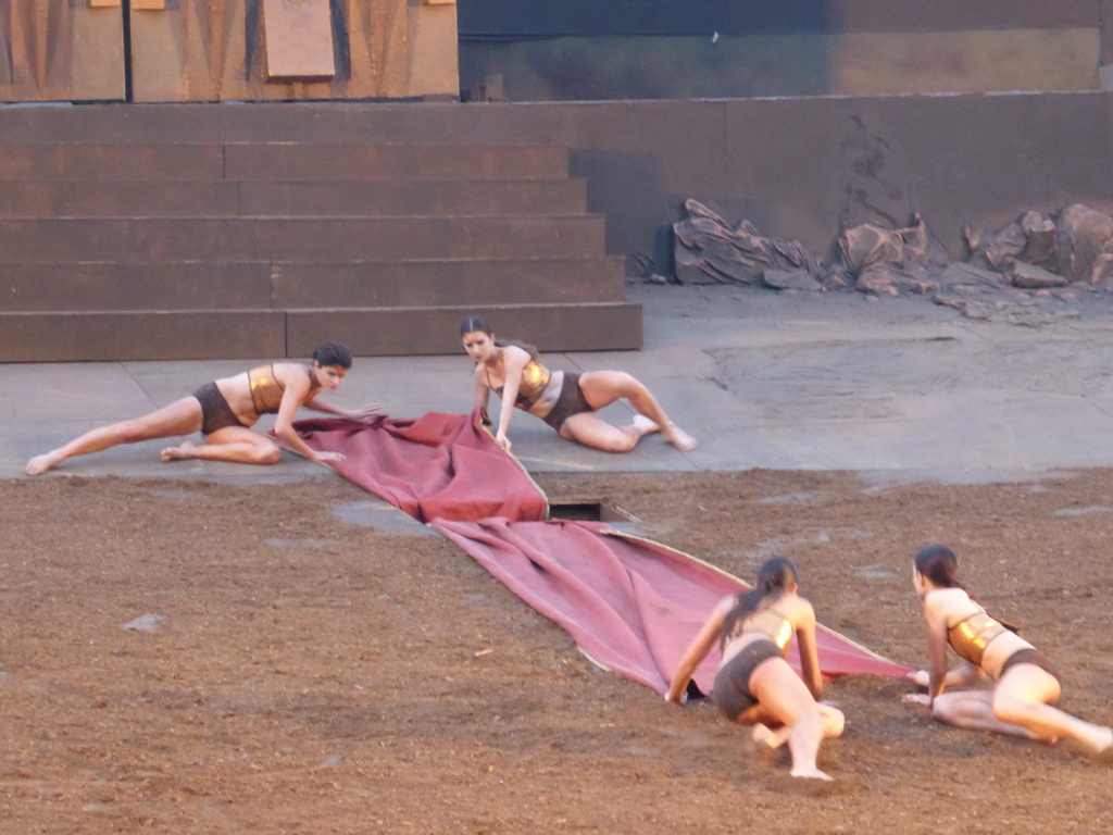 Female dancers laying down the purple tapestry to the gates of Argos at the stage of the Greek Theatre at the Parco Archeologico della Neapolis park, during the play `Agamemnon` by Aeschylus